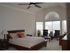 First floor master bedroom with high ceilings, sitting area and